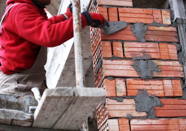 Chimney Repair Brooklyn contractors are workiing on repairing chimney brick repointing. This image was taken in February 2022